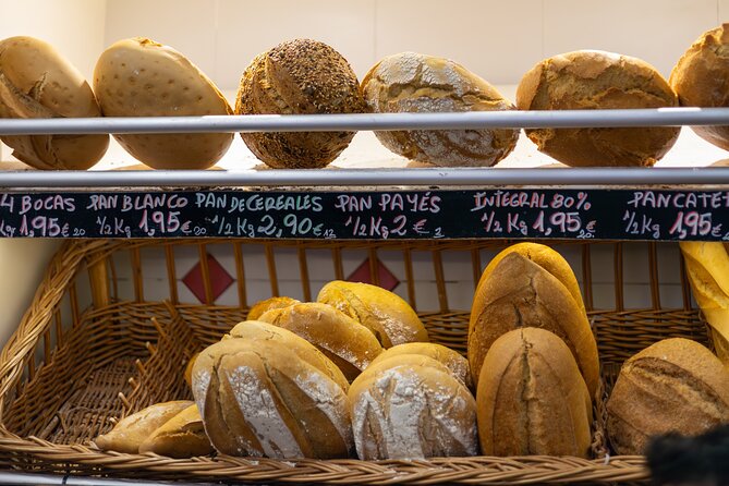 Malaga Food Tour with 12+ Tastings: Tapas, Olive Oil, Ham & More - Cathedral and Roman Theatre add the city context